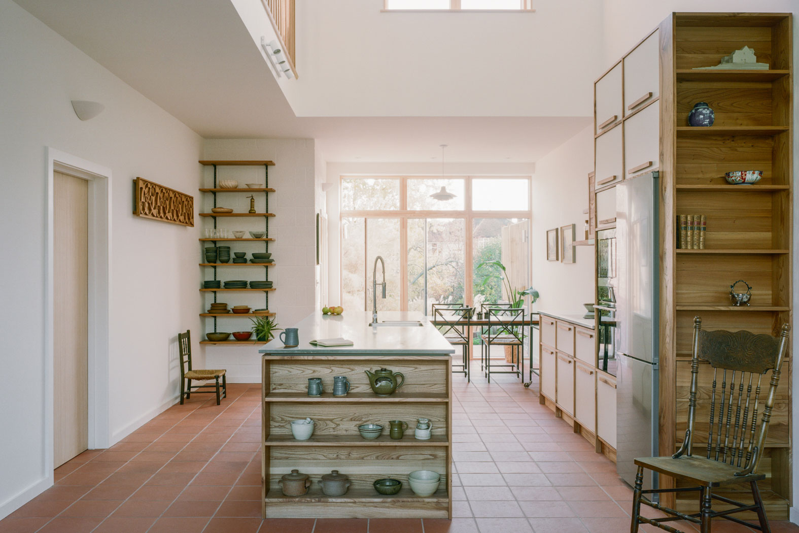 Kitchen in Lewes. View shows vintage table and chairs in dining area and kitchen cabinets made from reclaimed timber.