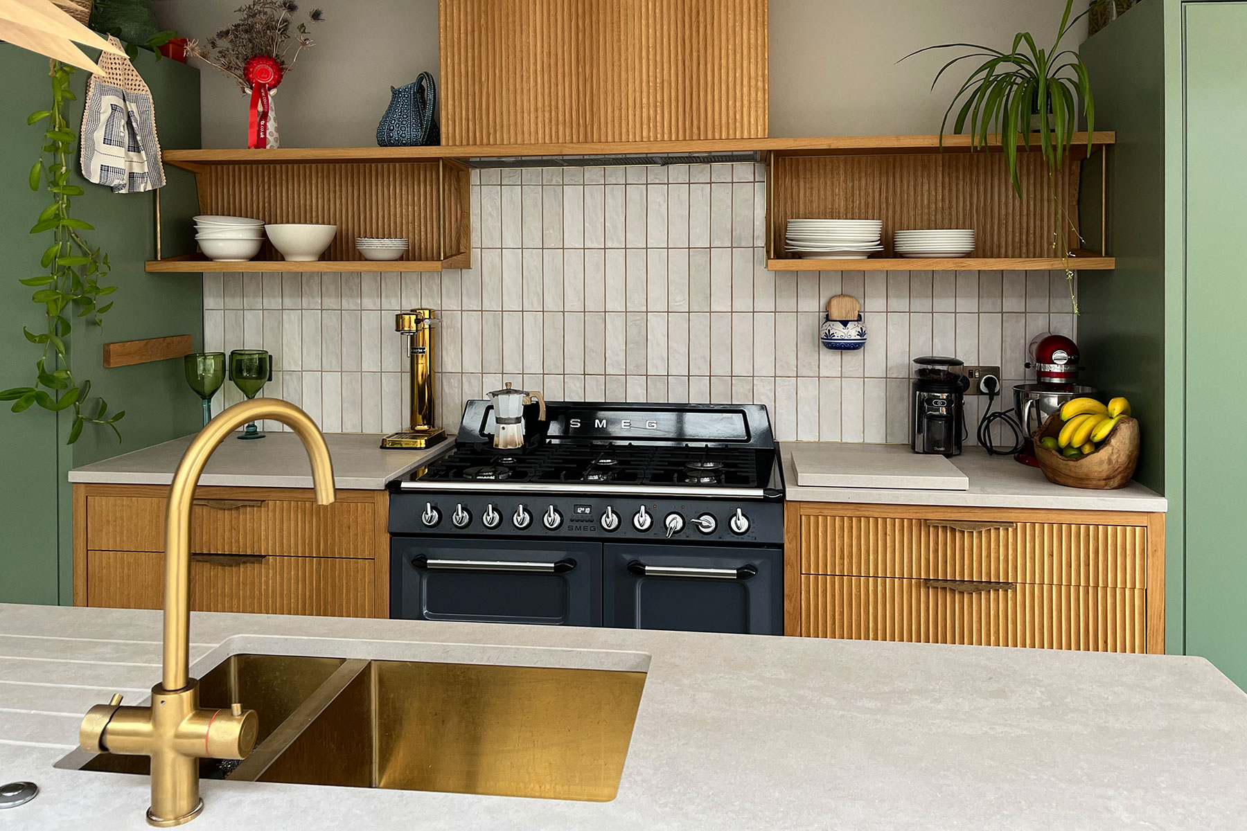 Fluted oak drawer fronts and panelling were paired with the dark olive paint to bring texture and warmth to this new bright space.