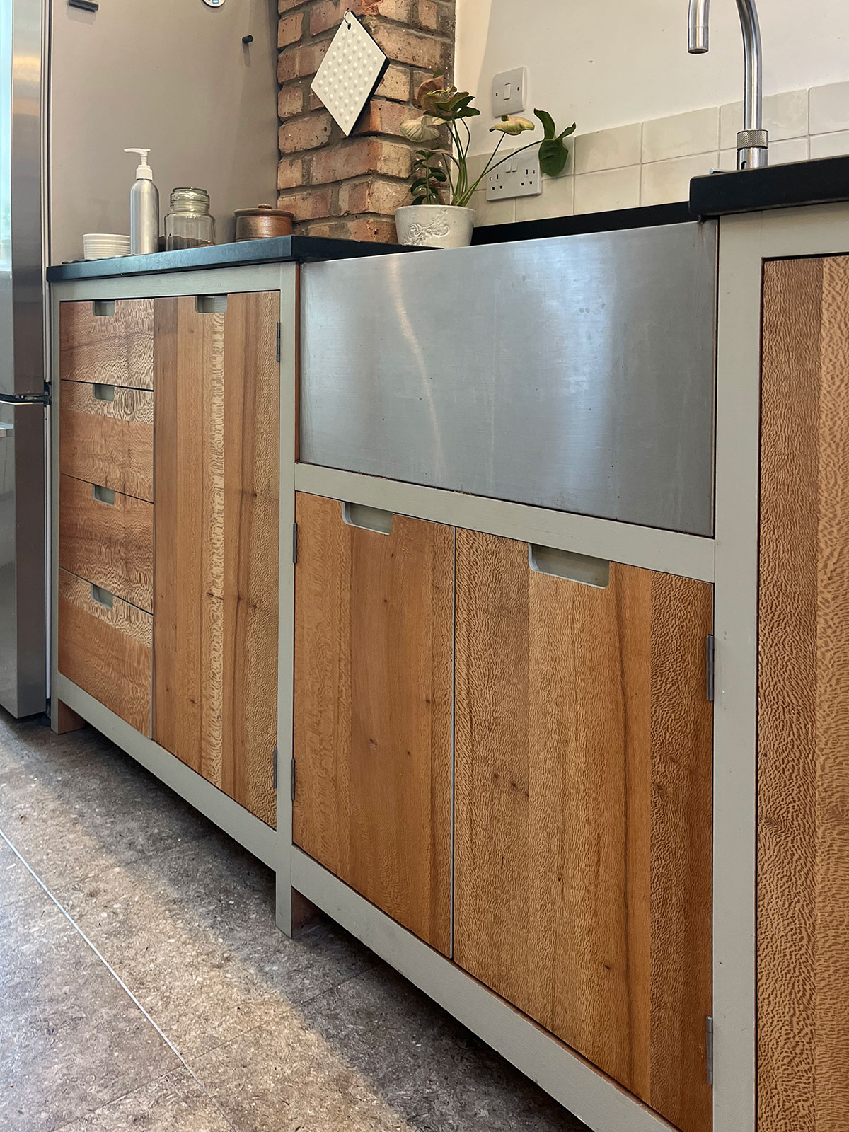 The use of colour on adjacent facets of the furniture highlights and frames the distinctive rich lace effect of the quarter sawn Plane of the cabinet fronts.