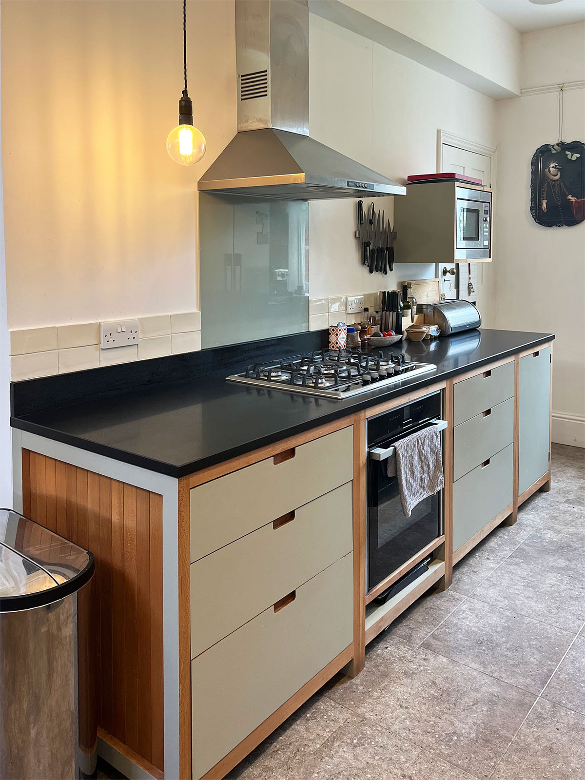 Honed granite worktops and a stainless steel butler sink were chosen to offer durability and also act as a balance to the colours of the timber and shade of formica.