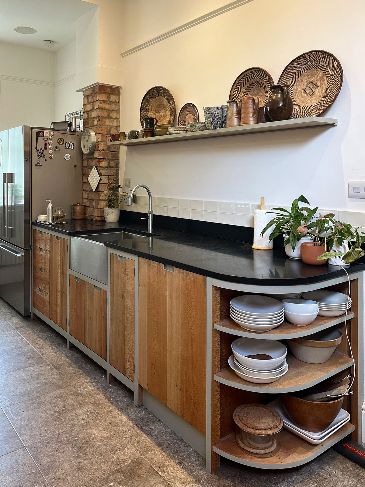 Handy crockery storage built under the counter end of this Greenwich kitchen.