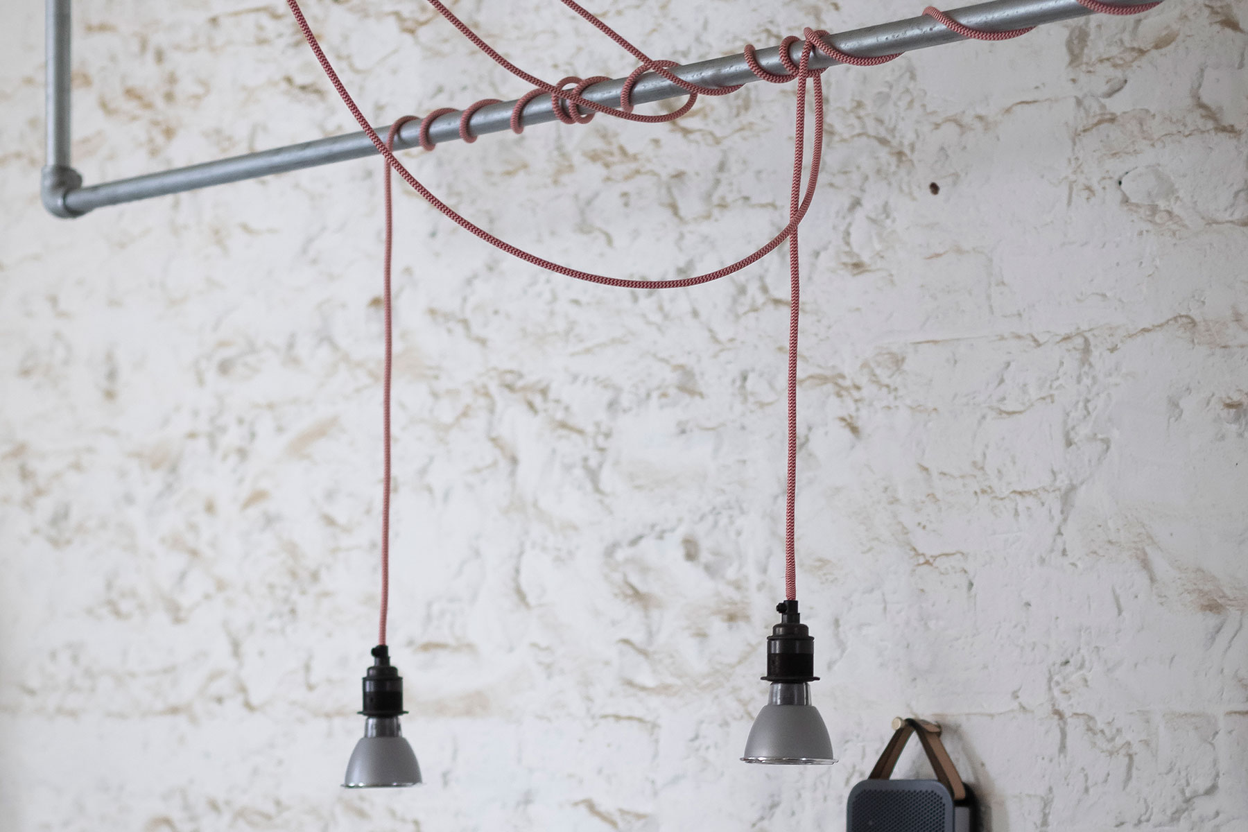 Detail of the lighting hung from an overhead bar.